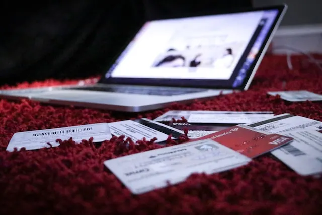 Credit card and laptop on bed