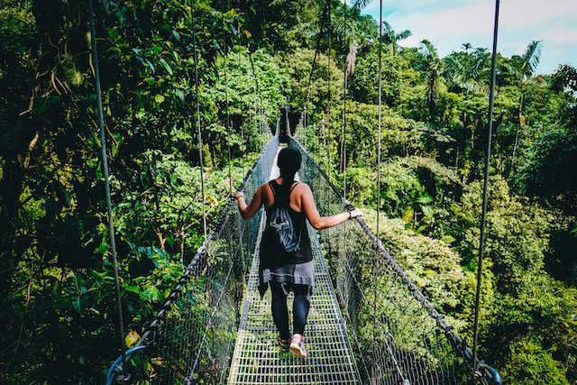 Girl on a bridge in rainforest of costa rica